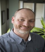 Headshot of author George Buss